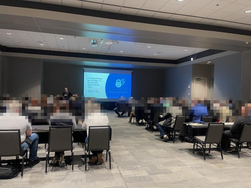 Jordan Arndt presenting on AI-powered cyber attack tools at a cybersecurity conference
